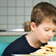 Child sniffing glass of milk